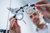 Image of optician holding a trial frame
